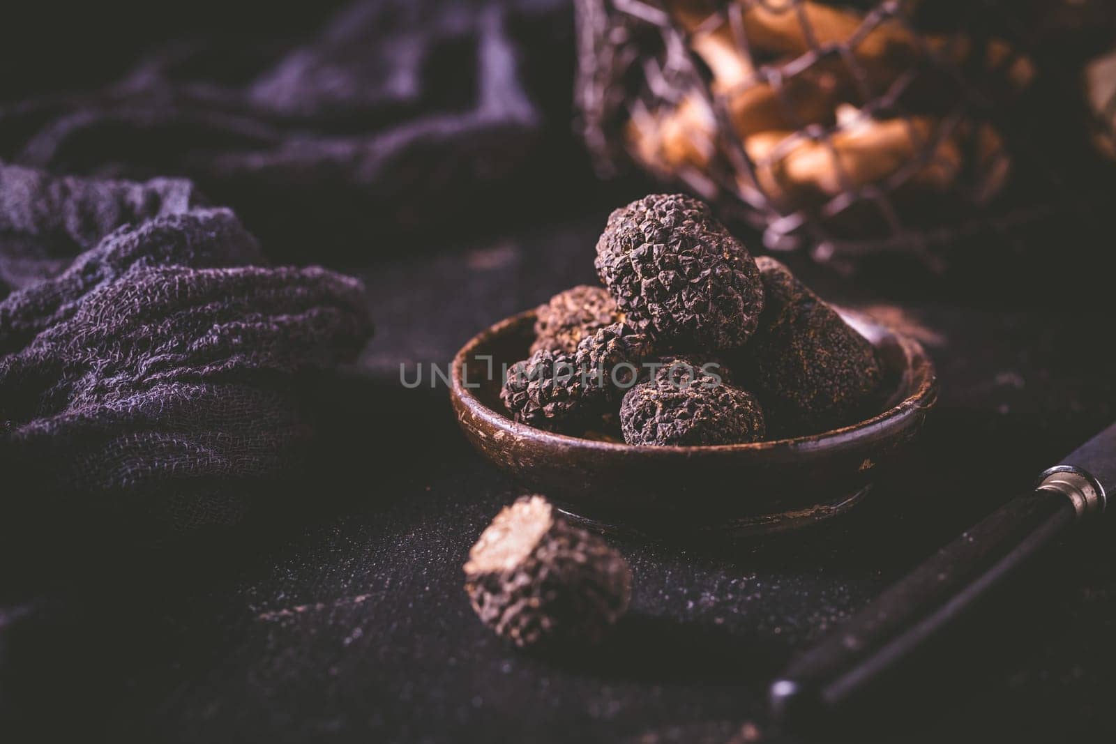 Expensive black truffles gourmet mushrooms  on kitchen table