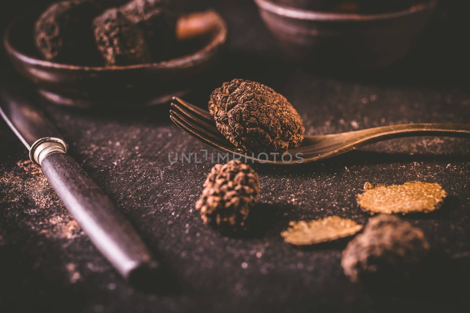 Expensive black truffles gourmet mushrooms  on kitchen table