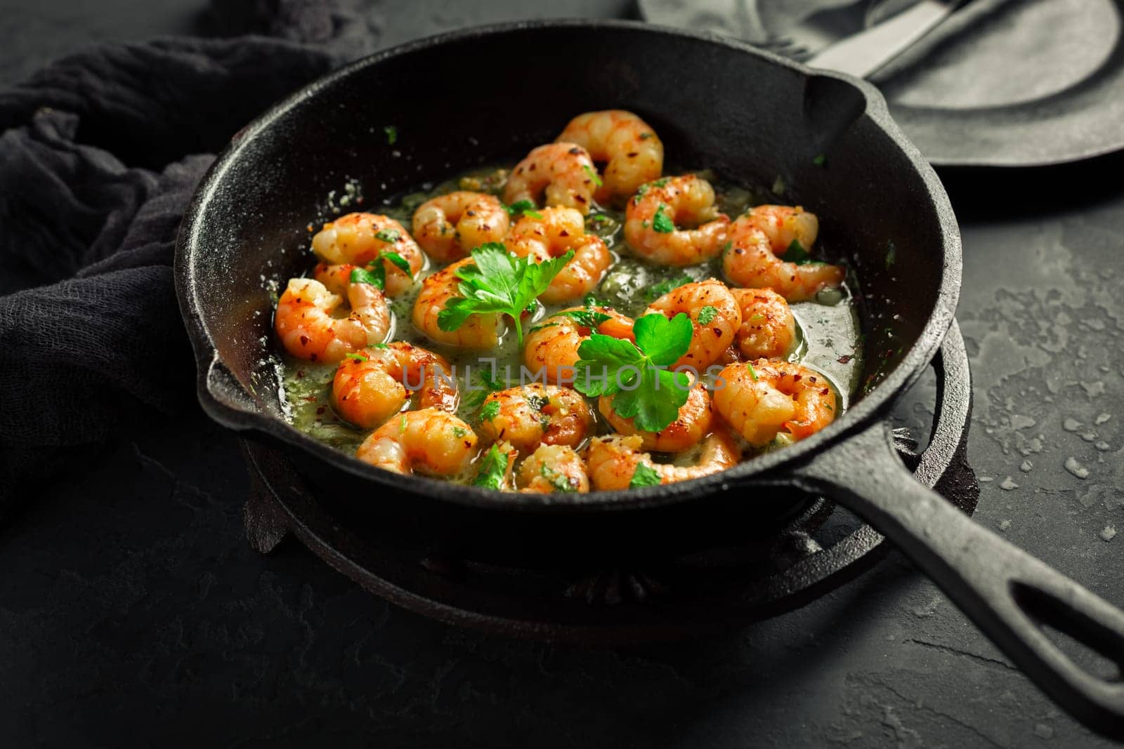 Roast Prawns Shrimps in a pan with herbs and garlic