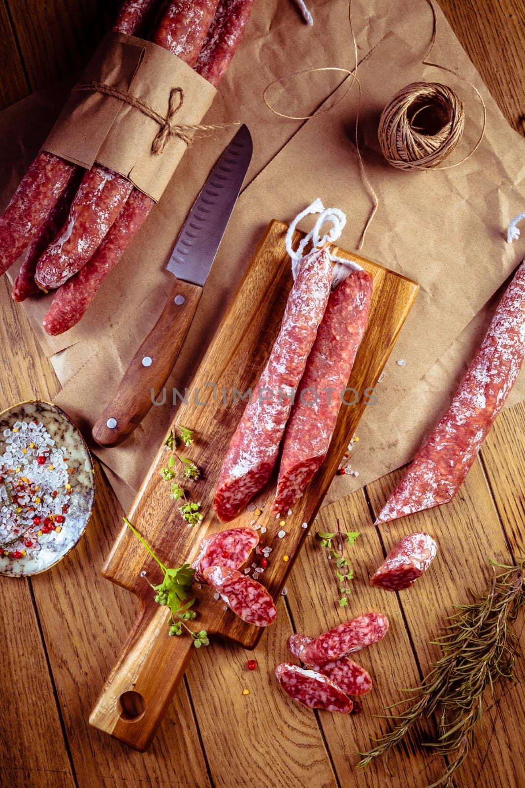 Traditional Spanish fuet on wooden background. Dry cured pork sausages with delicate taste.