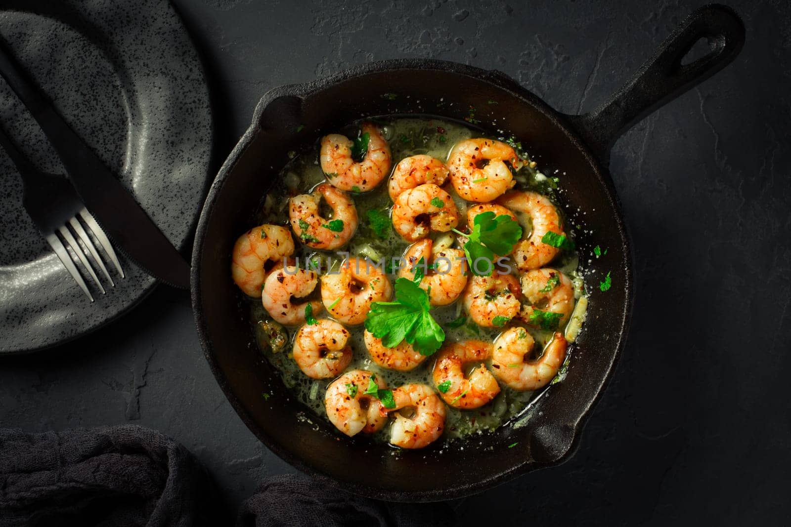 Roast Prawns Shrimps in a pan with herbs and garlic