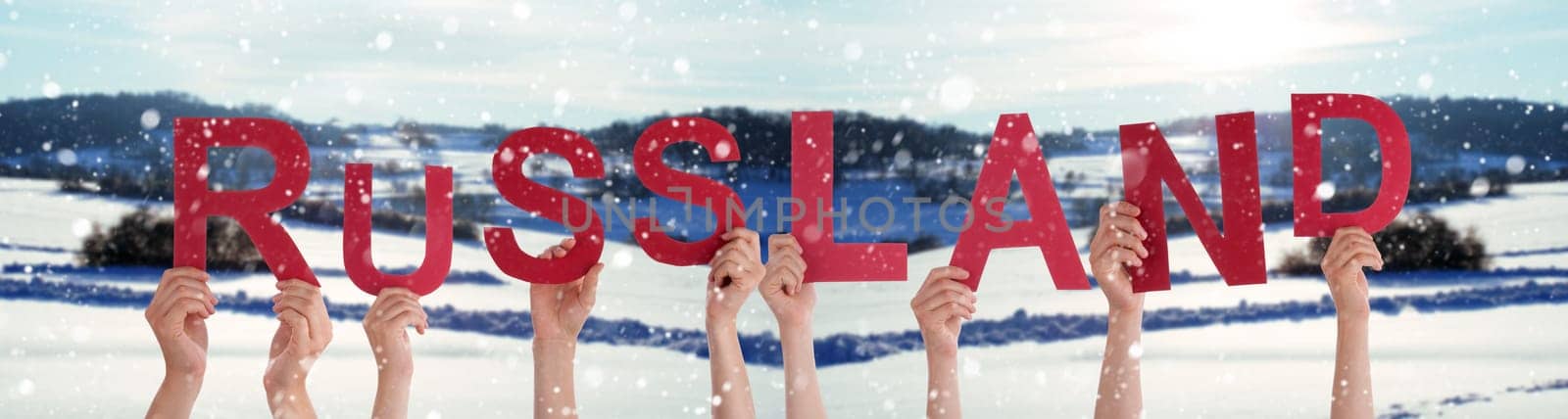 People Or Persons Hands Building German Word Russland Means Russia. White Winter Background With Snowflakes And Snowy Landscape.
