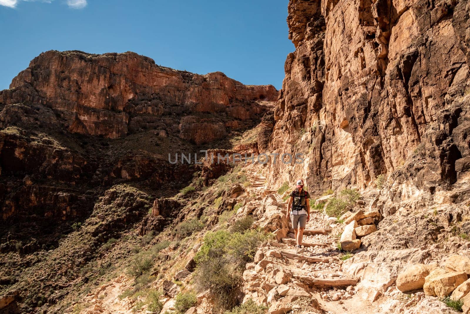 A female person hiking alone the Bright Angel Trail in the Grand Canyon, USA