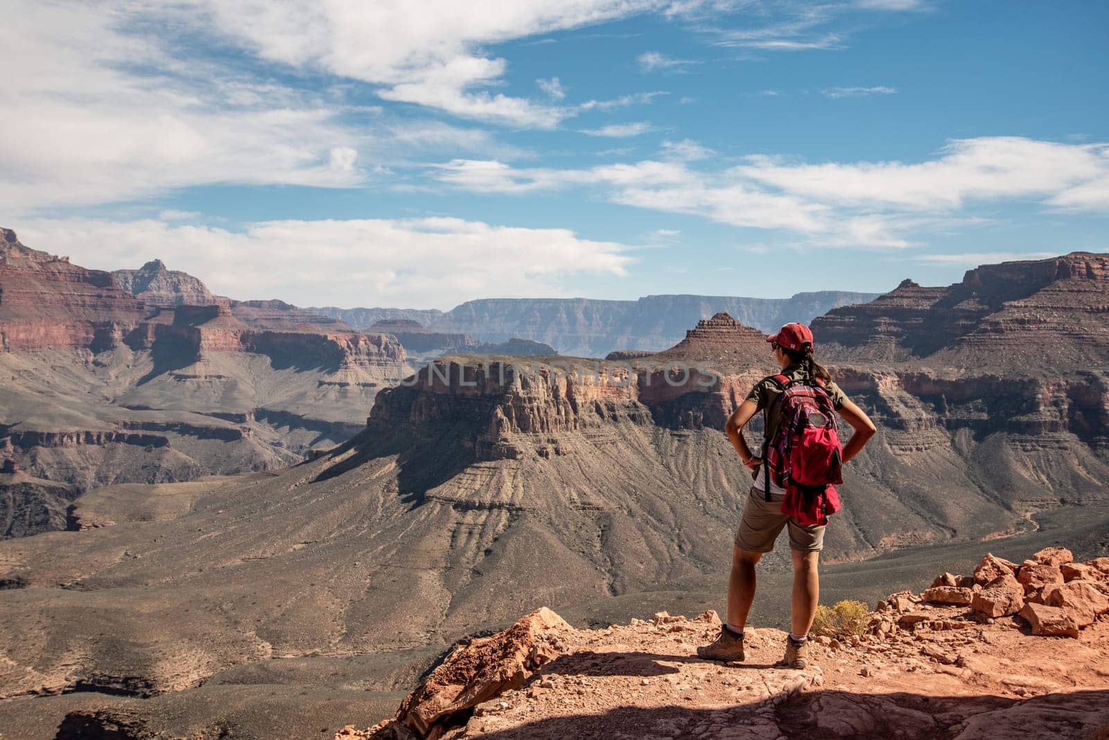 A female hiker enjoying the view from the famous Grand Canyon from South Kaibab trail, USA
