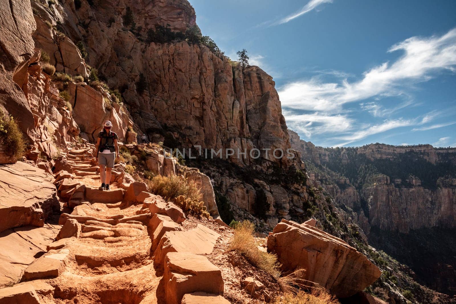 A female person hiking alone the Bright Angel Trail in the Grand Canyon, USA