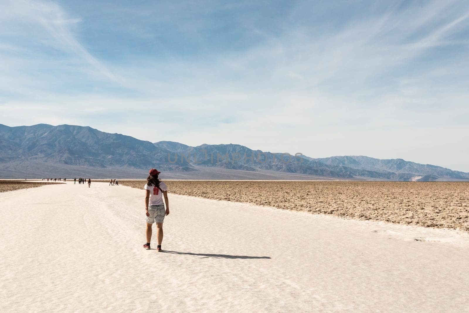 A lonely person hiking through famous Badwater Basin in the Death Valley, USA
