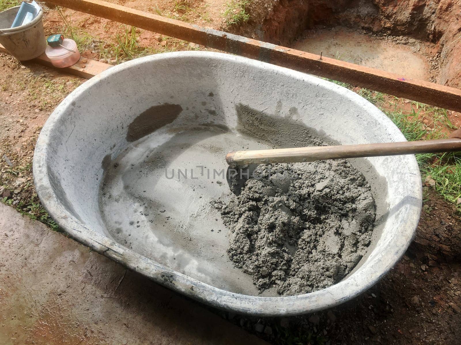 Mixing of stone, cement, sand together to make a strong concrete floor, Construction concept