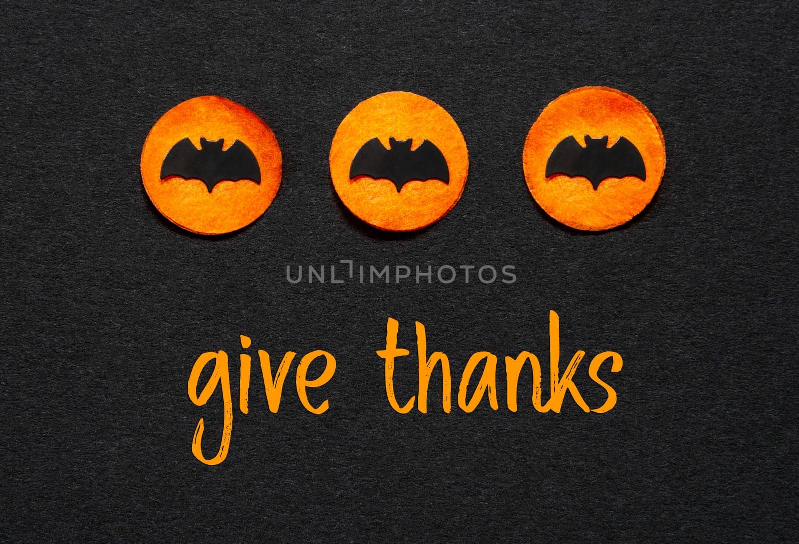 Black Halloween Background With Three Orange Dots With Bats And Text Give Thanks