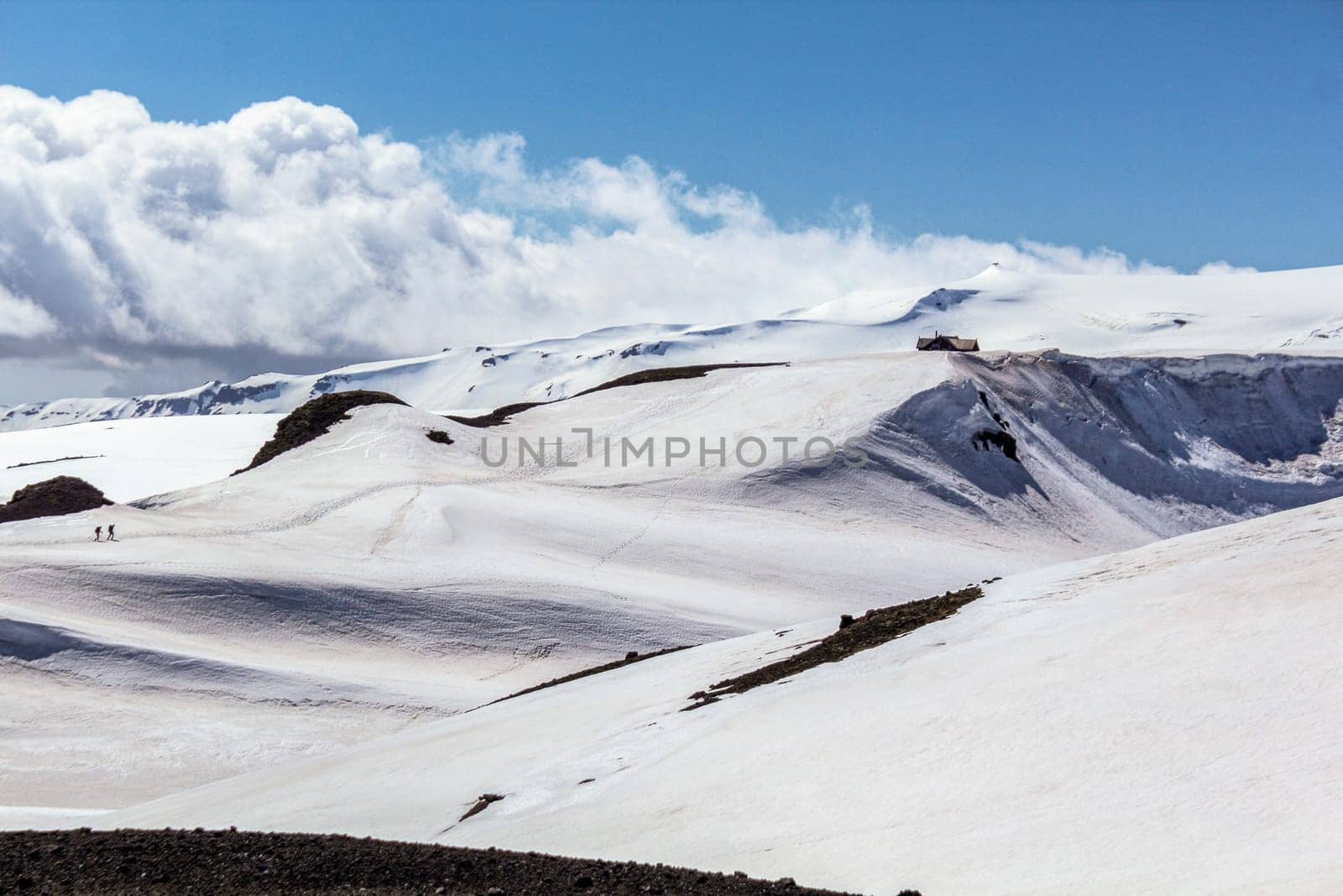Sun and beautiful clouds over snowy landscape at Fimmvorduhals hiking trail, Iceland, highlands of Iceland