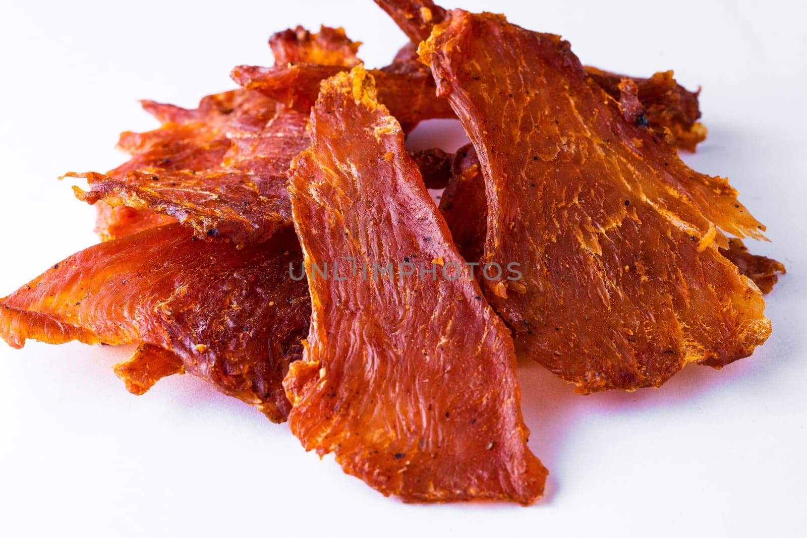 Beef jerky pieces isolated on white and black background