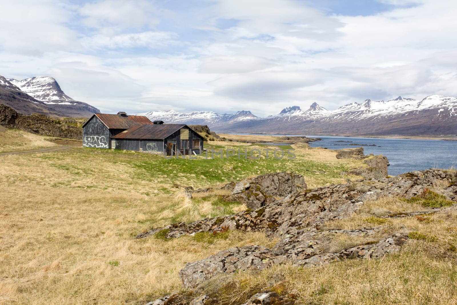 Old abandoned house within Icelandic fjord landscape