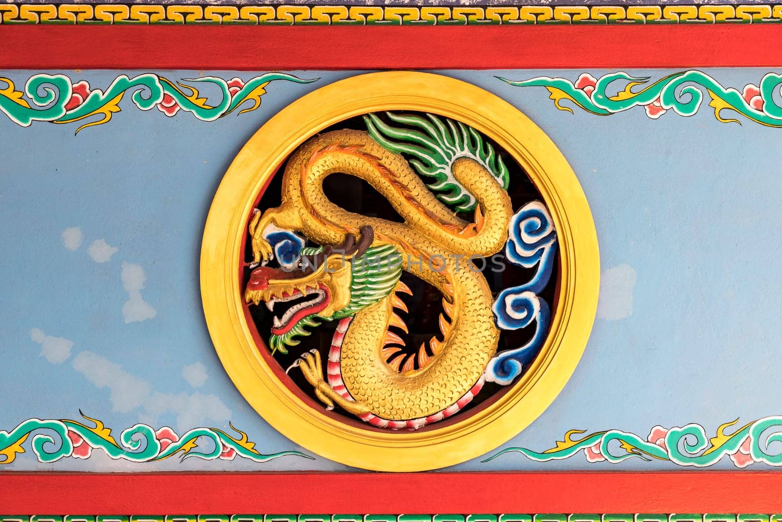 A circular carving of a golden dragon mounted on the shrine's wall symbolizes good luck, power and authority. It is a beautiful work of art that reflects the art and culture of China and East Asia.