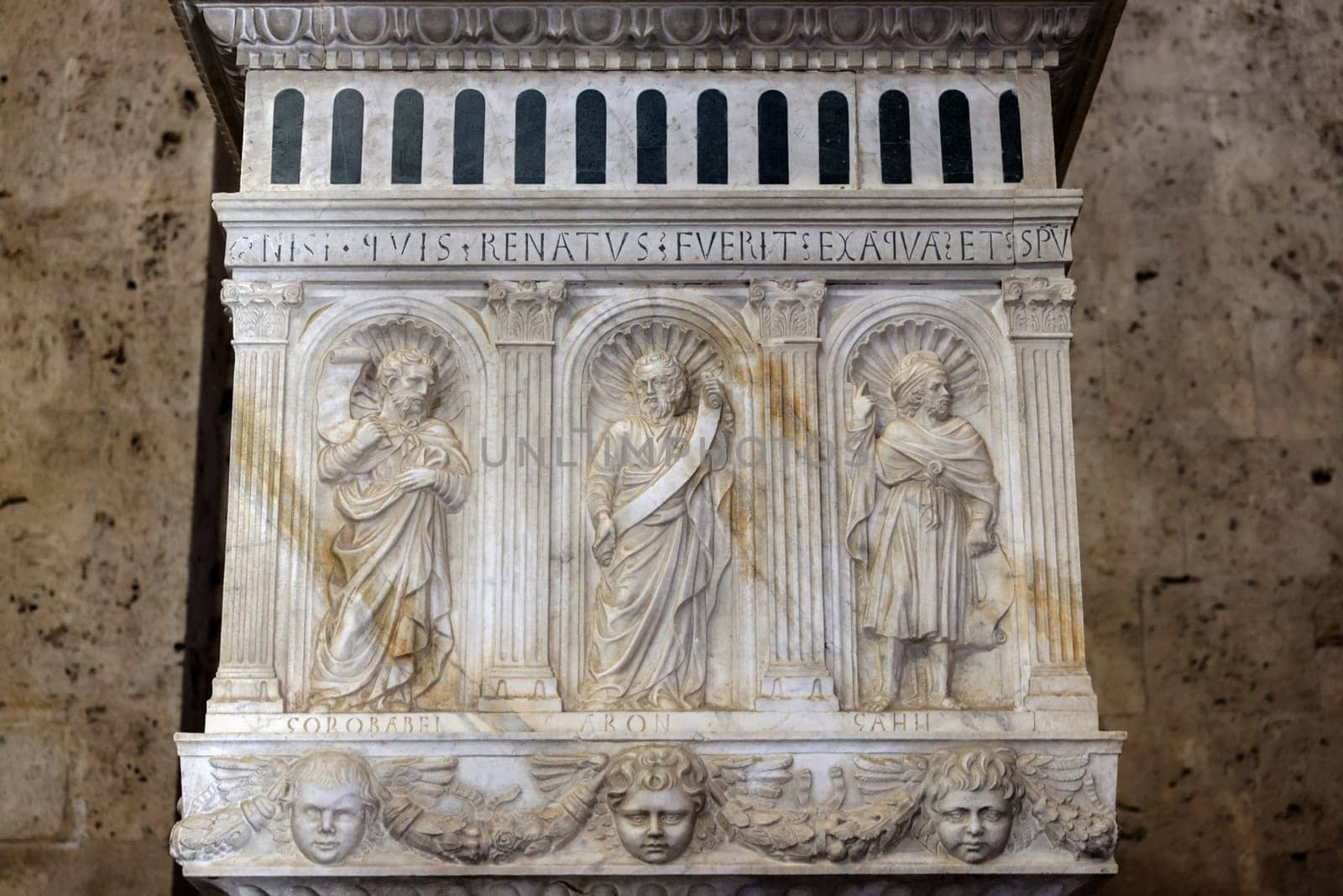 Massa Marittima, Italy - Sept 11, 2022:  Monumental baptismal font, with a rectangular bath surmounted by a small temple. The baptistery dates from 1267. Cathedral of Saint Cerbonius in Massa Marittima. Italy