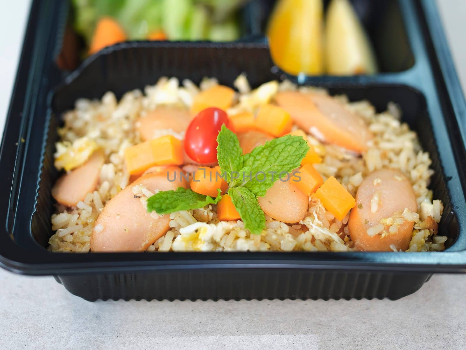 Fried rice with sausage and mixed vegetable .