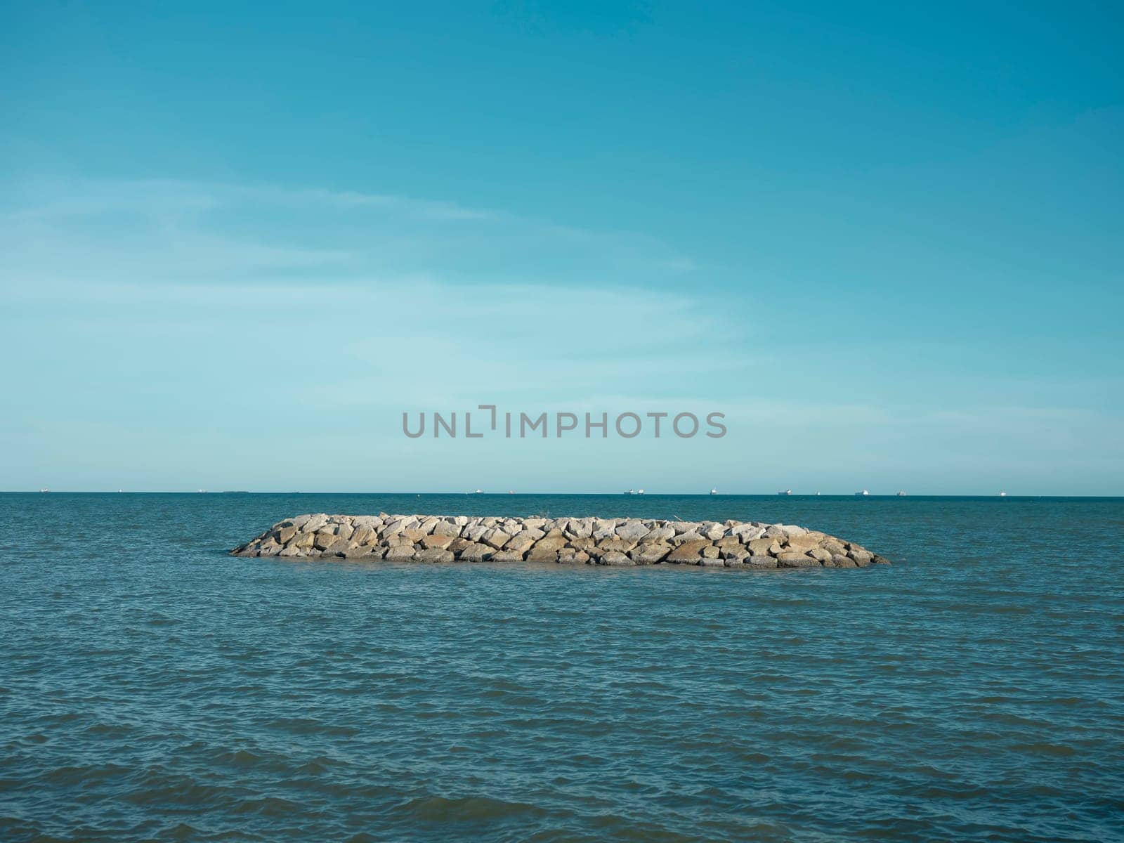 Sea beach with stone wall and sand at  beach , Map Ta phut , Rayong ,Thailand.