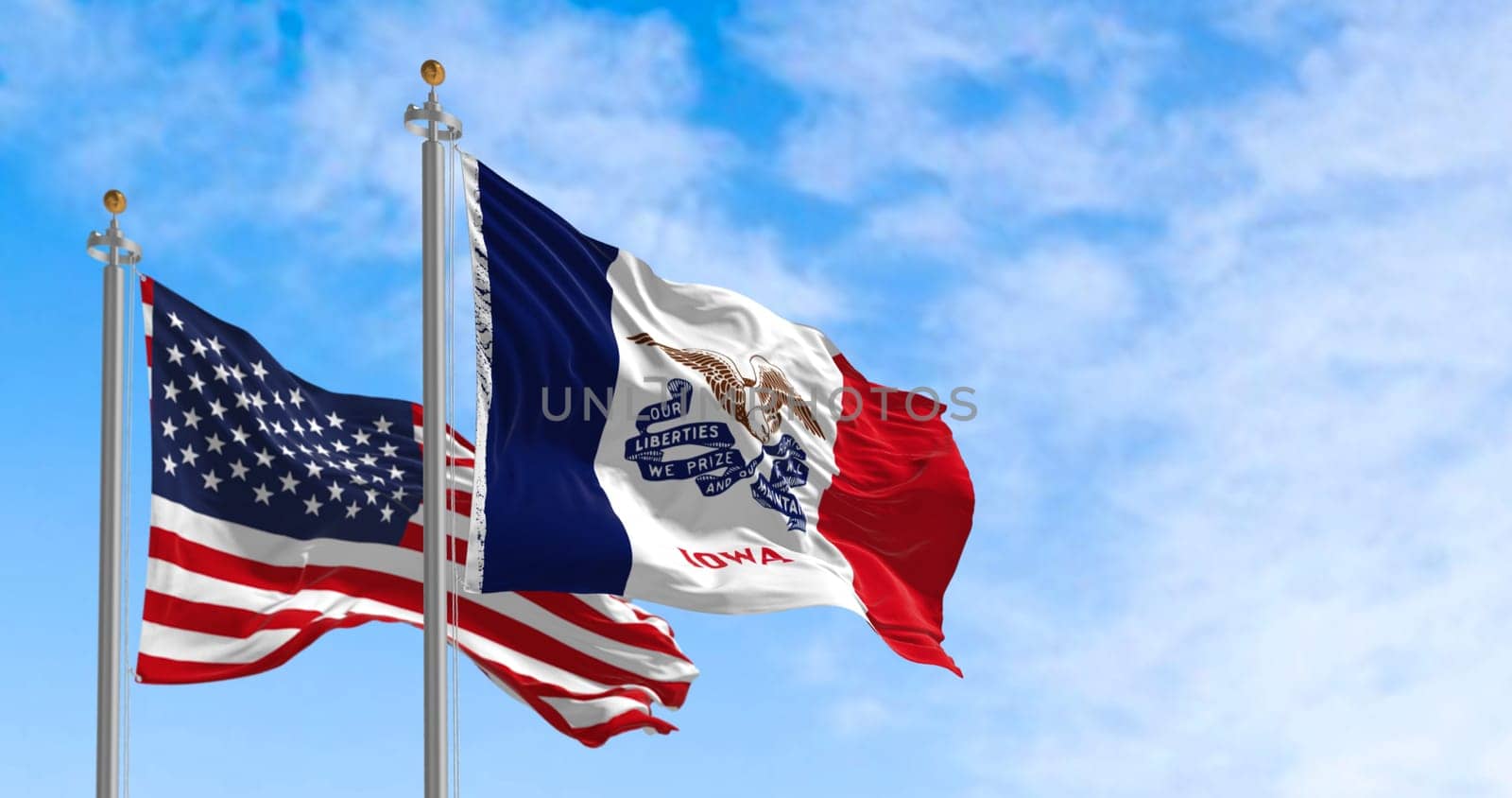 Flags of Iowa and the United States waving in the wind on a clear day. State in the upper Midwestern region of the United States. 3d illustration render. Fluttering fabric.