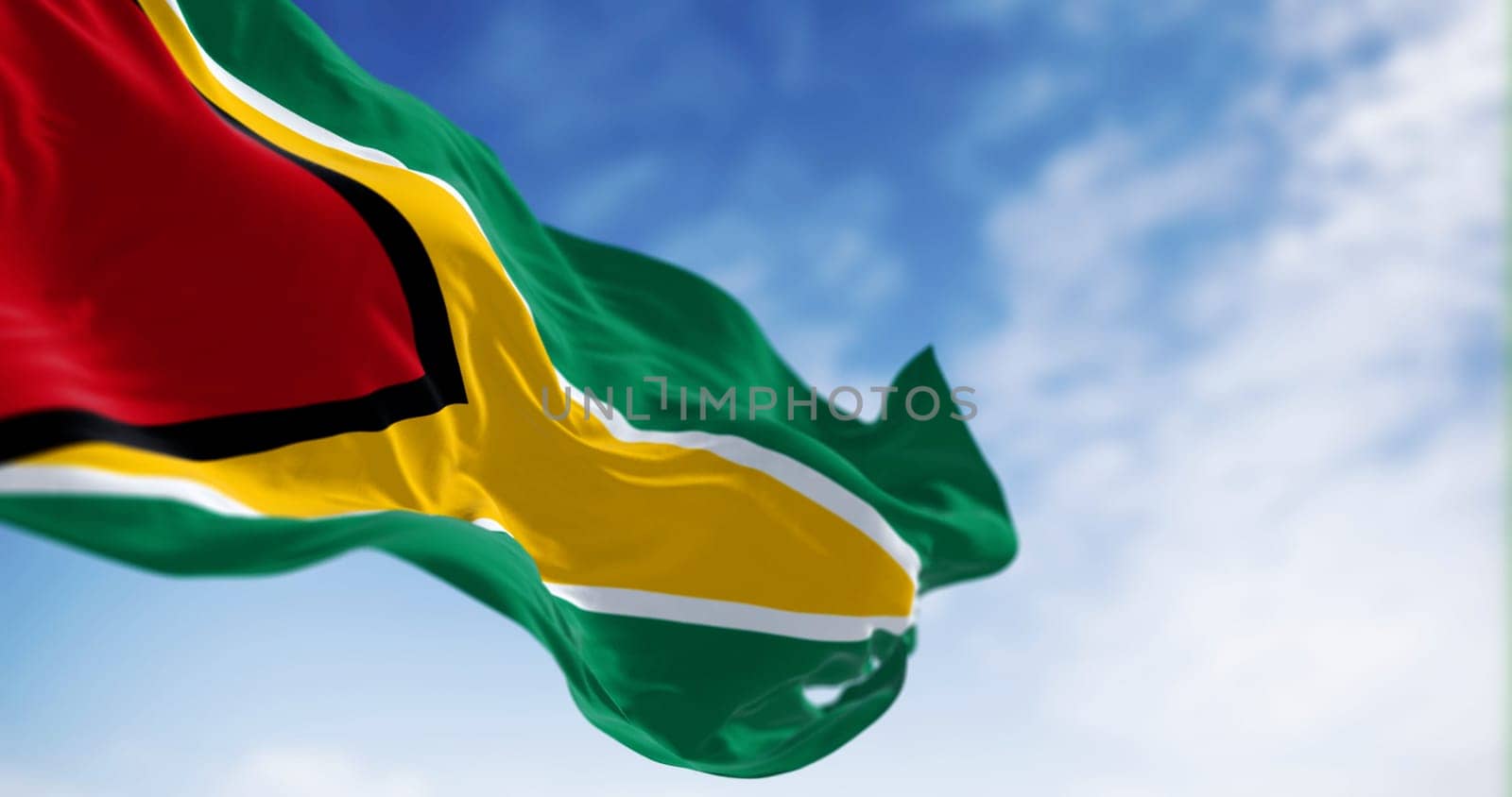 Close-up view of the Guyana national flag waving in the wind. Green field with red, gold, black, and white triangles. The Golden Arrowhead. 3d illustration render. Fluttering fabric