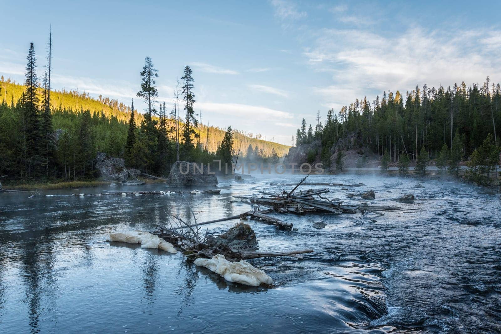 Early morning at a quiet river, fog is rising, Yellowstone National Park, USA