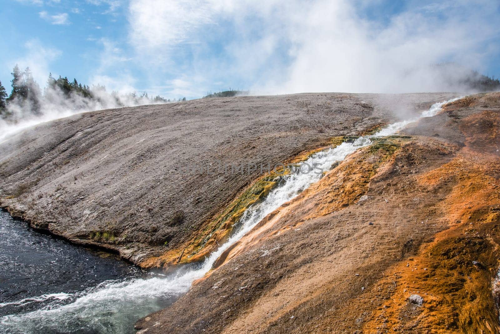 A little stream of hot water flowing in a natural pool, Yellowstone NP, USA
