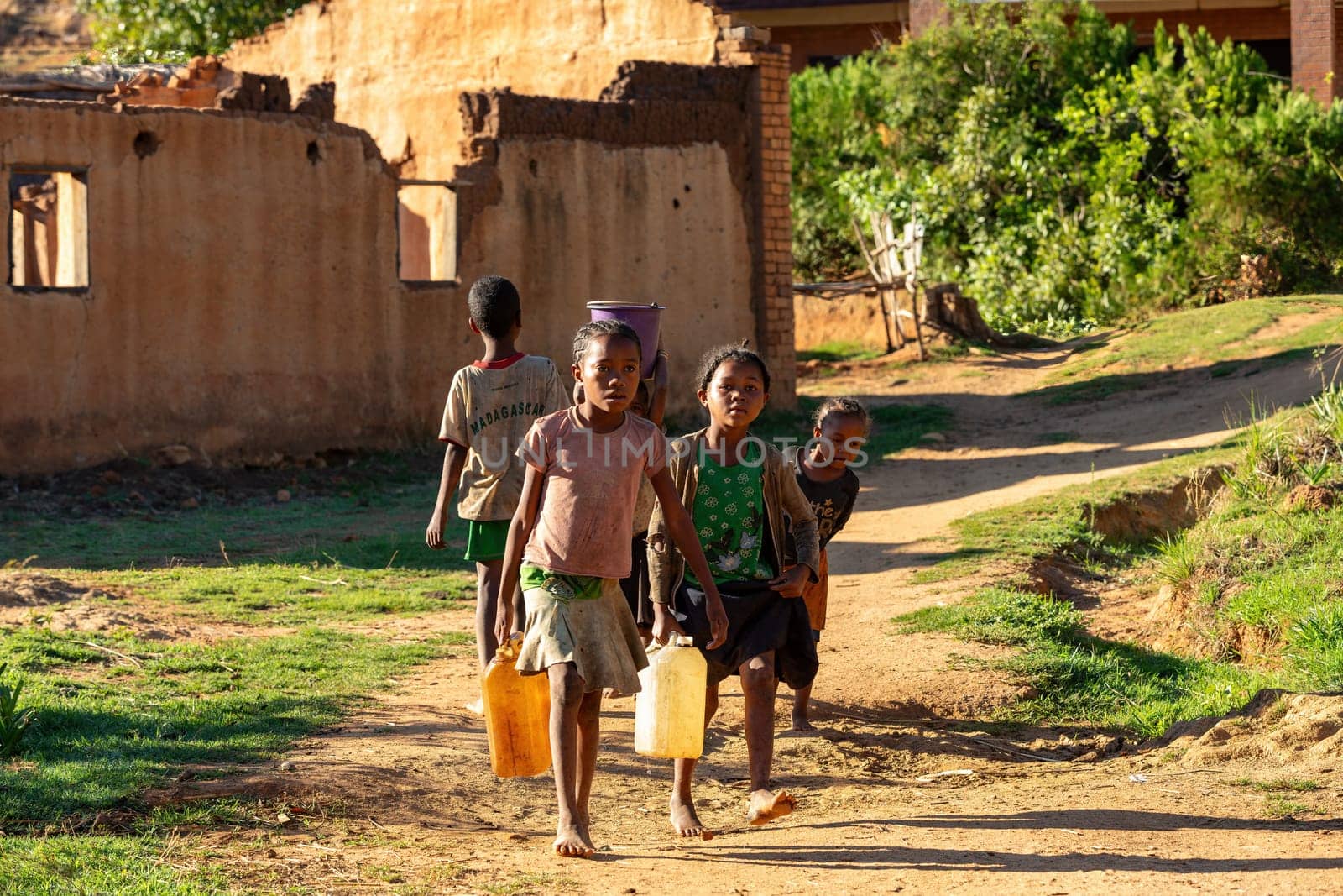 Lakanga, Andringitra mountain, Madagascar - November 15, 2022: , Madagascar - November 15, 2022: Malagasy girls from Lakanga village delivering water for cooking in the morning.