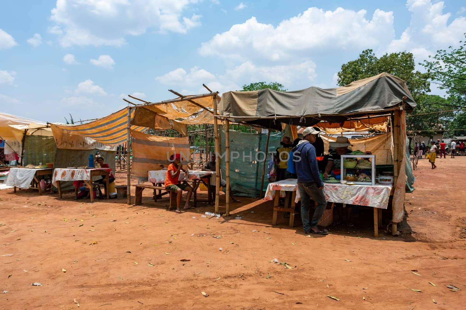 Mandoto, Madagascar - November 9th, 2022: A bustling street market in Mandoto city with fast food in street marketplace.