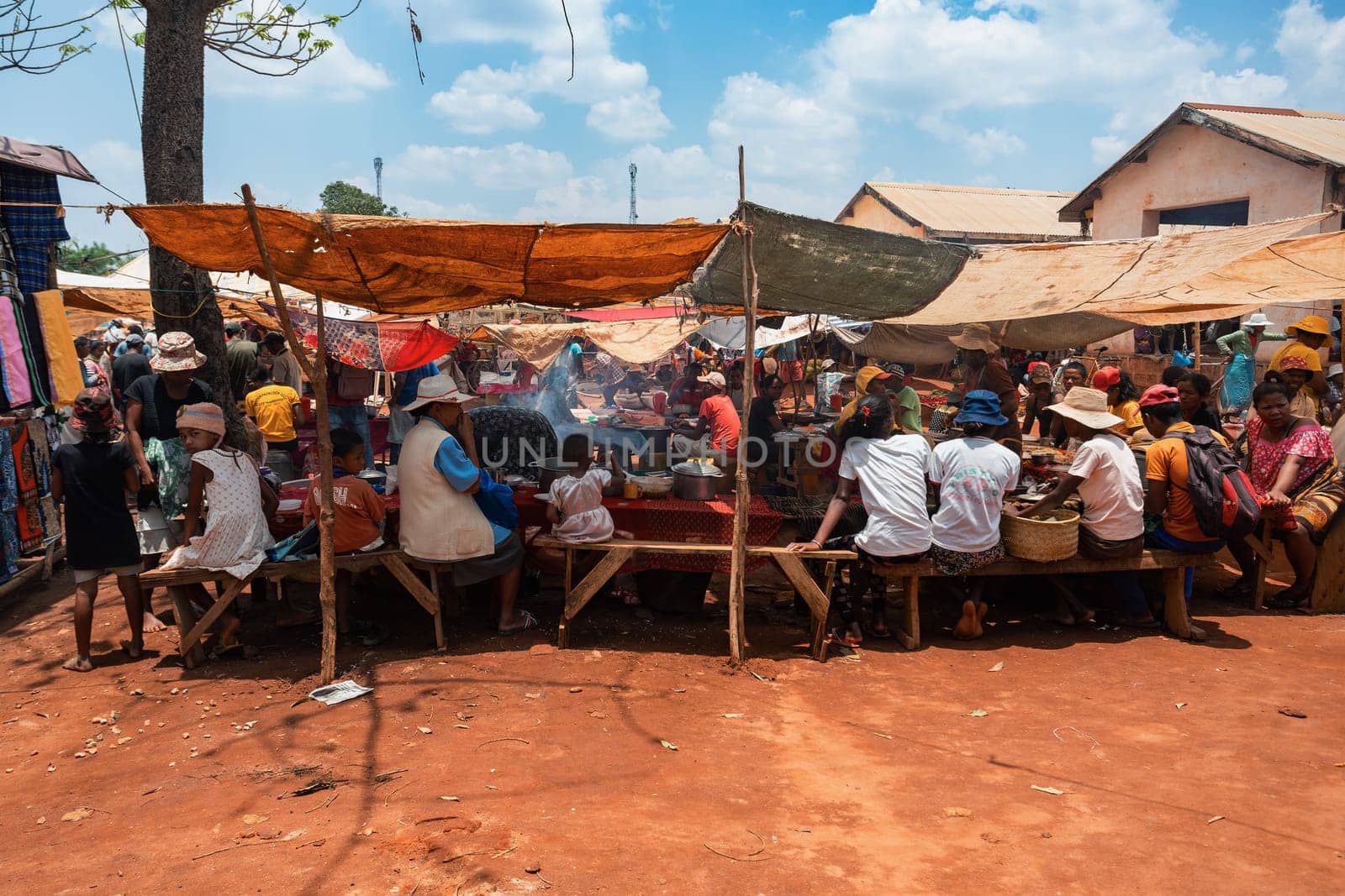 Mandoto, Madagascar - November 9th, 2022: A bustling street market in Mandoto city with fast food in street marketplace.