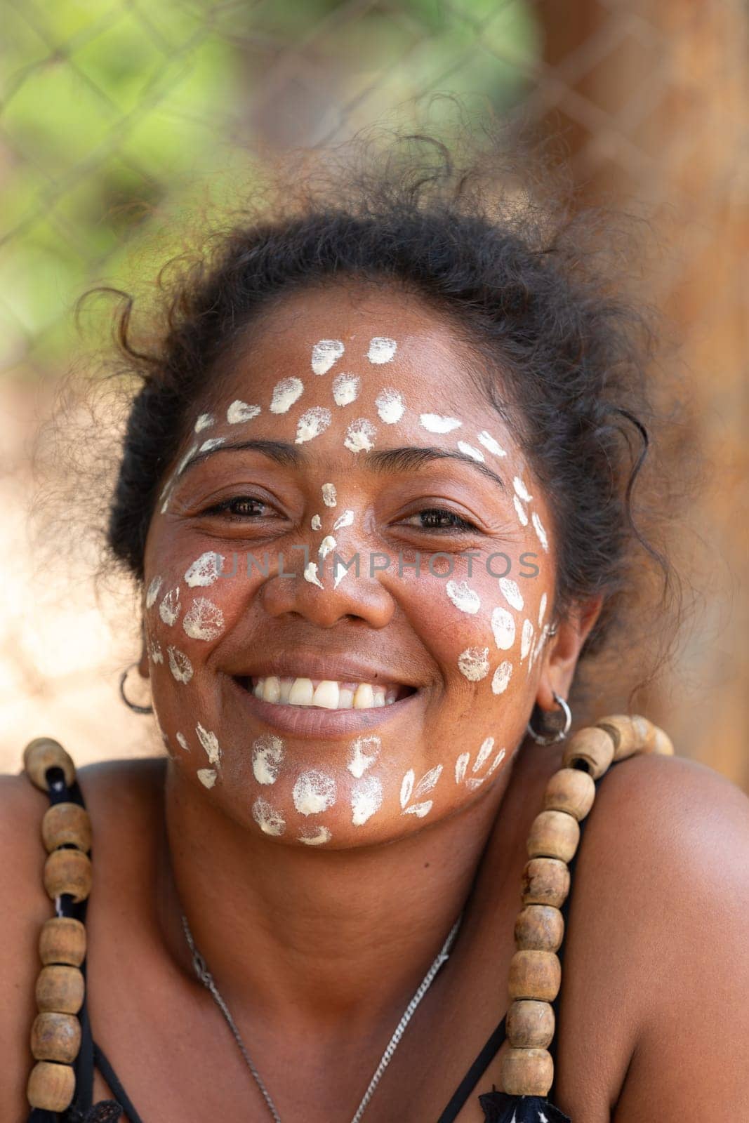 Miandrivazo, Madagascar - November 2nd 2022 - Close up portrait of a Malagasy woman with white dots painted on her face as part of a traditional culture.