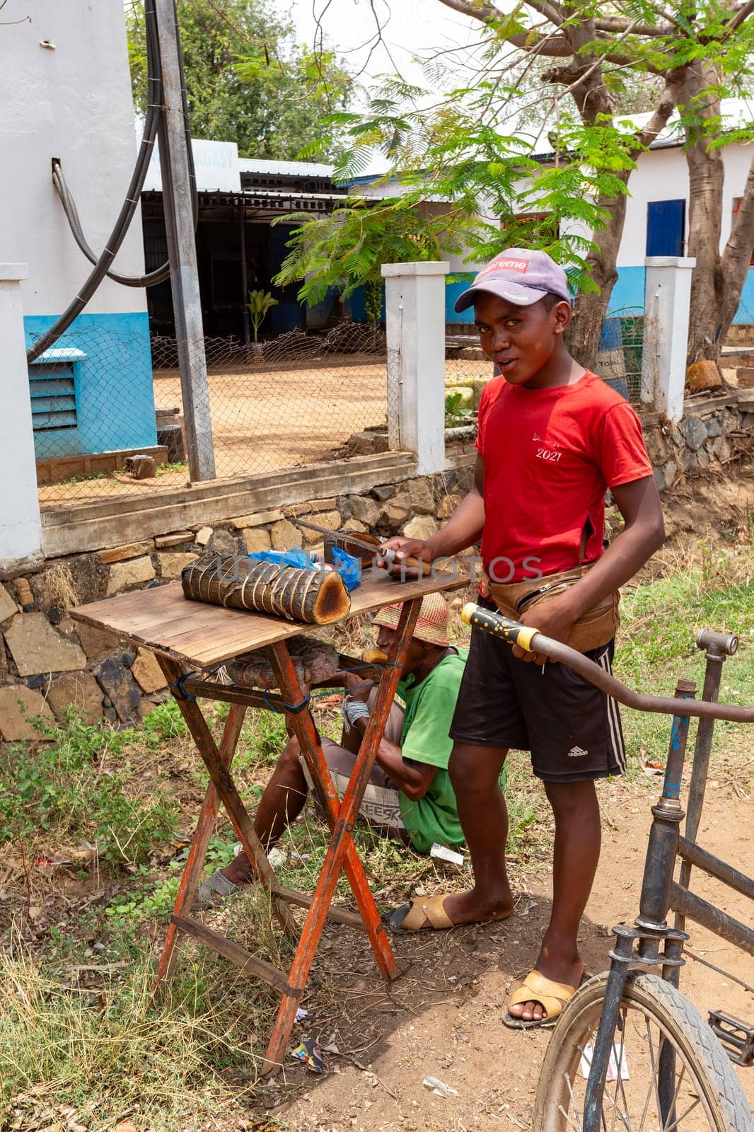 Miandrivazo, Madagascar - November 2nd 2022: Street vendors selling Koba, a traditional Malagasy sweet made from ground peanuts, brown sugar, and rice flour, reflecting the local culinary heritage.