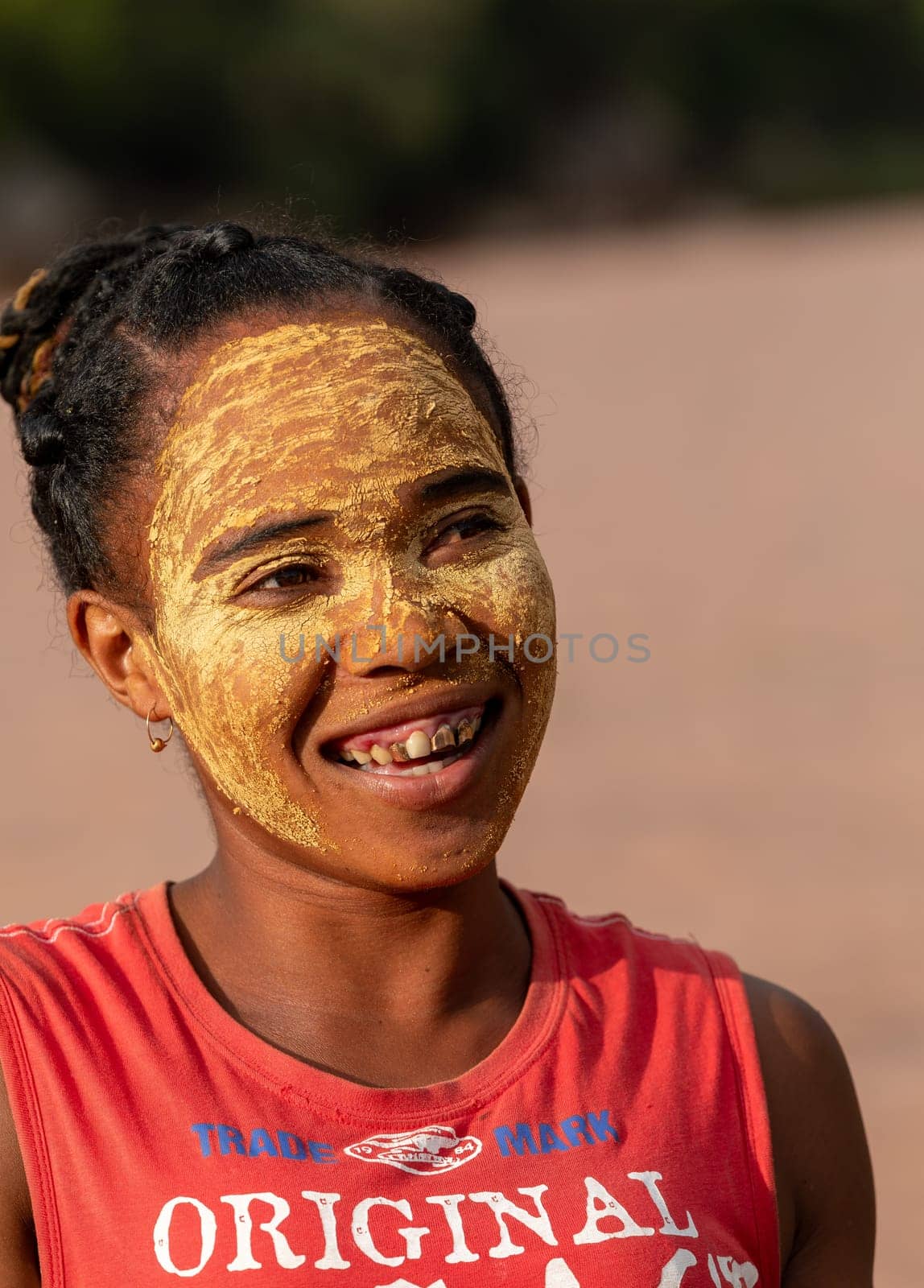 Bekopaka, Madagascar - November 4. 2022: Malagasy woman in ferry on rover Mania. Malagasy women paint their faces to protect their faces from the sun.