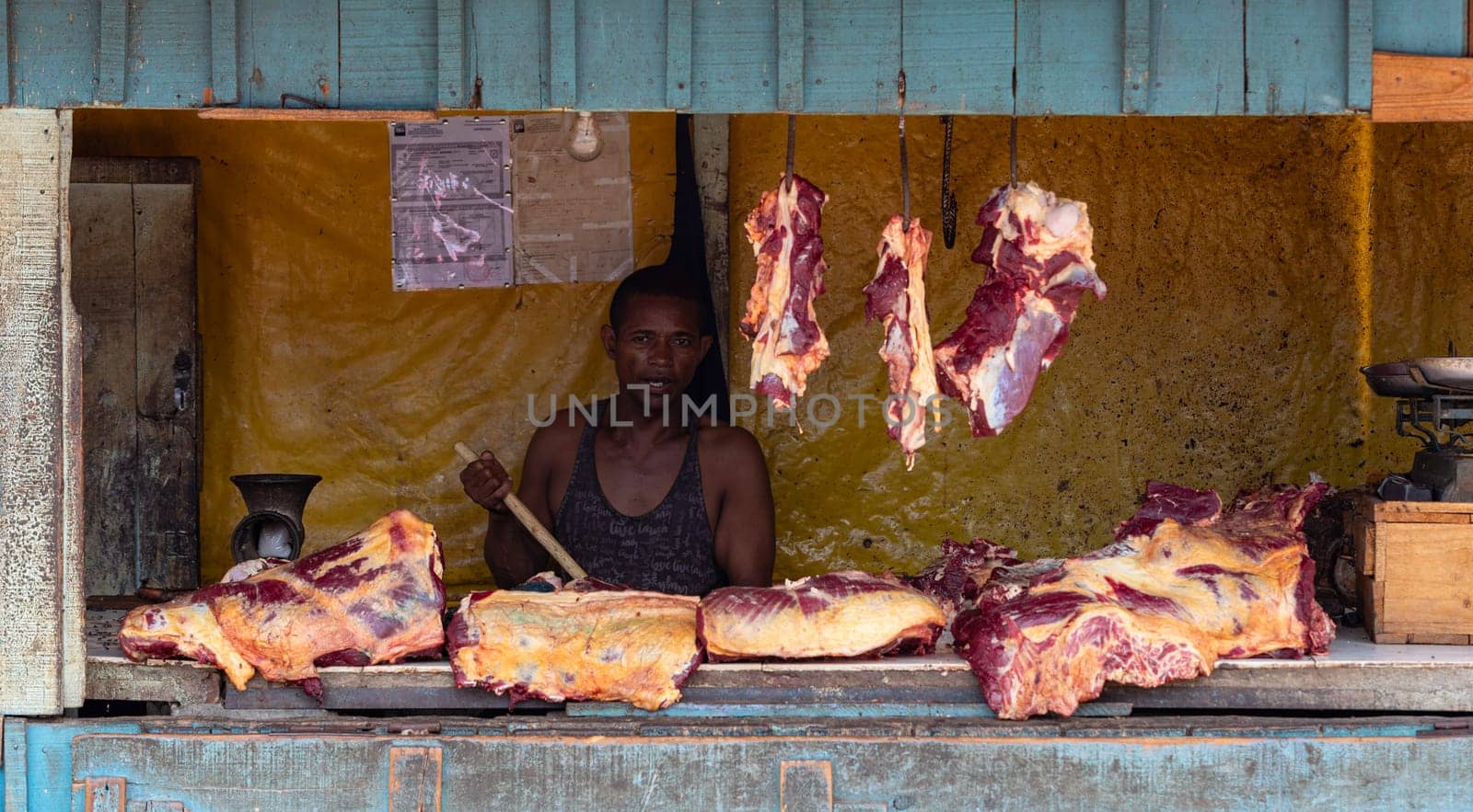 Miandrivazo, Madagascar - 02/11/2022: A hot day in Miandrivazo, Madagascar, with a street stall butcher shop open with raw meat.