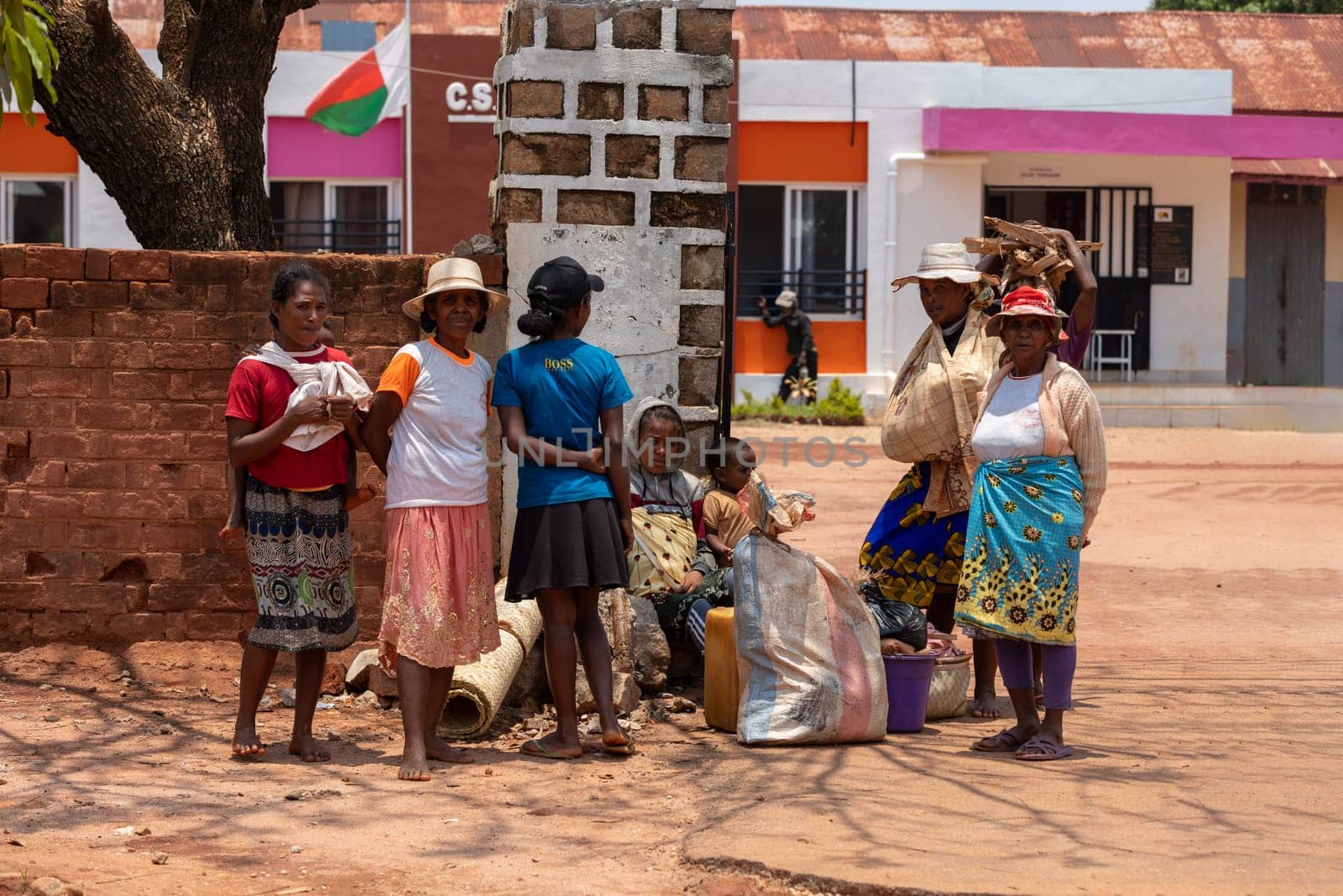 Mandoto, Madagascar - November 9th 2022: Malagasy woman resting on the street in shadow.