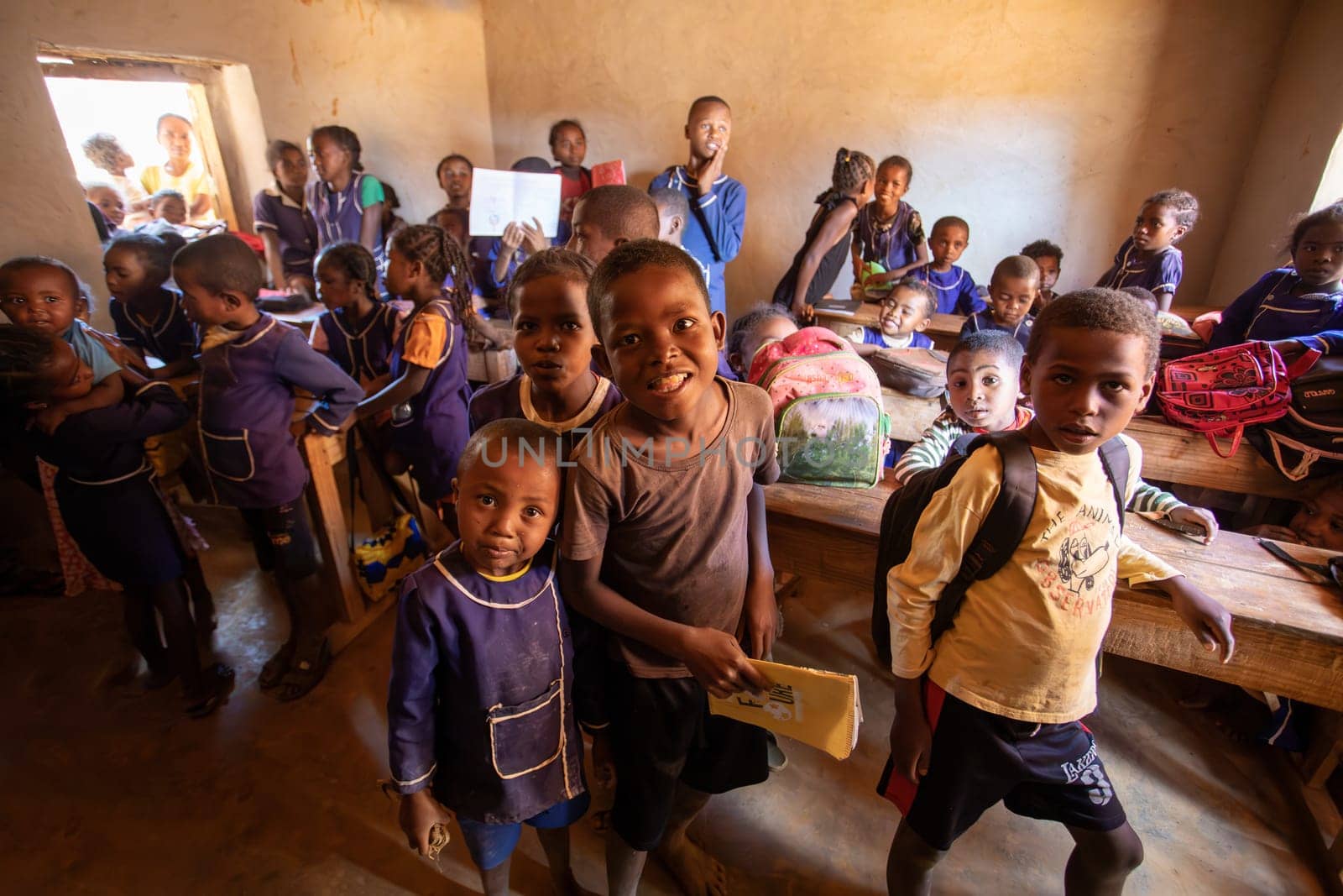 Vohitsaoka, Ambalavao, Madagascar - November 17. 2022: Happy Malagasy school children students in classroom. School attendance is compulsory, but many children do not go to school.