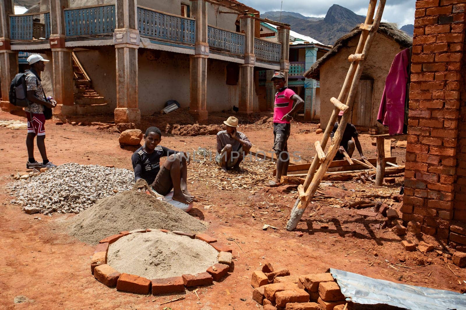 Andringitra Mountains, Madagascar - November 17, 2022: Malagasy men were breaking stones into gravel needed for the reconstruction and construction of the house.