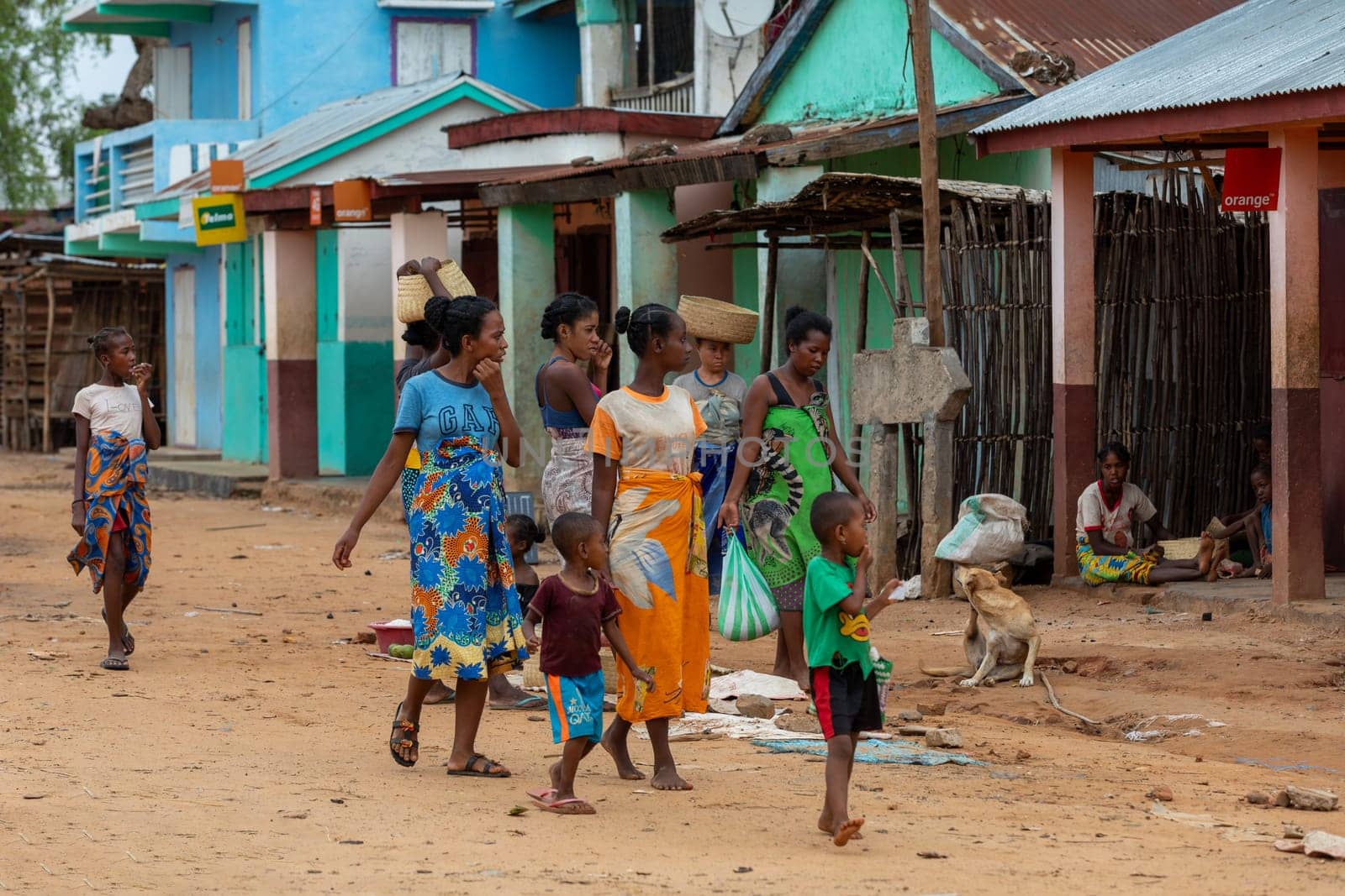 Bekopaka, Madagascar - November 6, 2022: Malagasy woman's with children walking down the street.