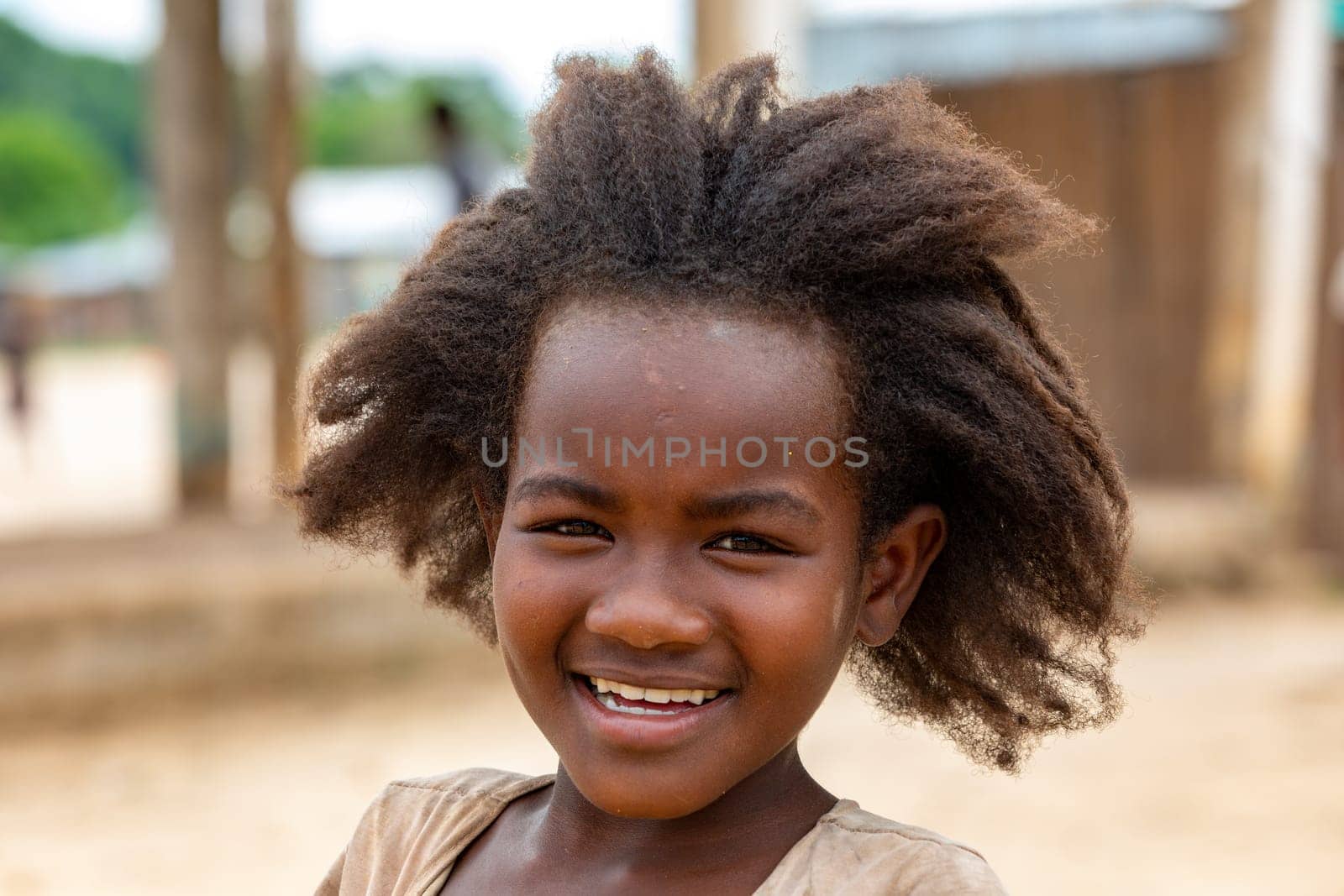 Bekopaka - Antsalova, Madagascar- November 6. 2022: Small cute Malagasy girl with long hair , happy little dancer on celebration in village Bekopaka, region Melaky, Madagascar.