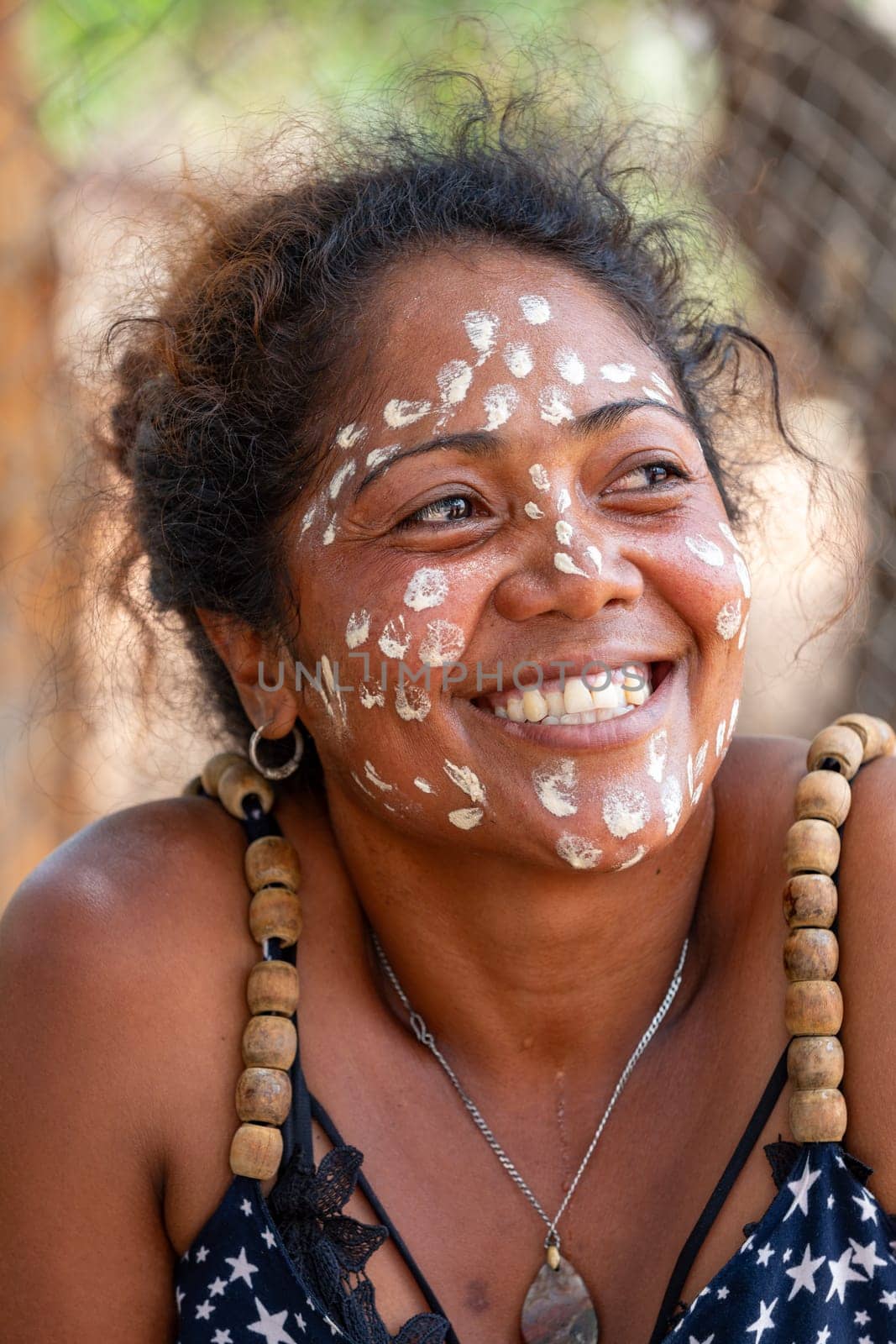 Miandrivazo, Madagascar - November 2nd 2022 - Close up portrait of a Malagasy woman with white dots painted on her face as part of a traditional culture.