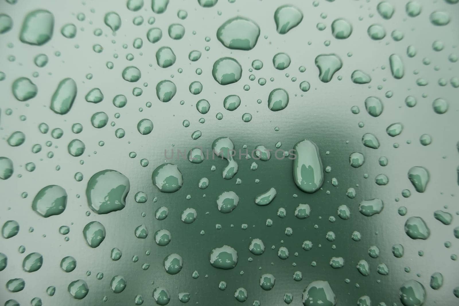 Detail of raindrops on a metallic background, cold and winter