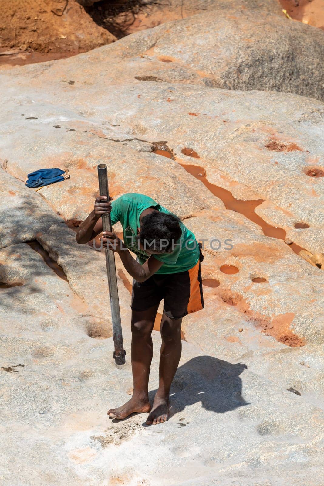 Dabalava, Madagascar - November 1, 2022: Local people mine for gems and pan for gold in a river. If they're lucky, they'll find a little gold flake