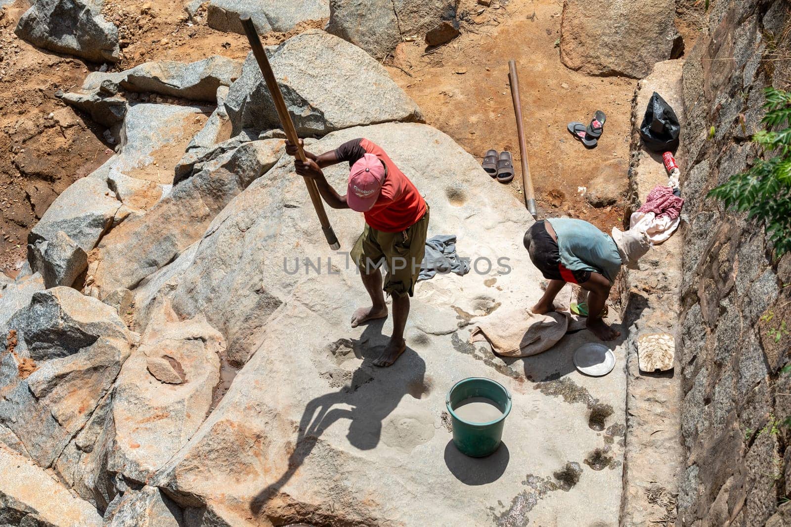 Dabalava, Madagascar - November 1, 2022: Local people mine for gems and pan for gold in a river. If they're lucky, they'll find a little gold flake