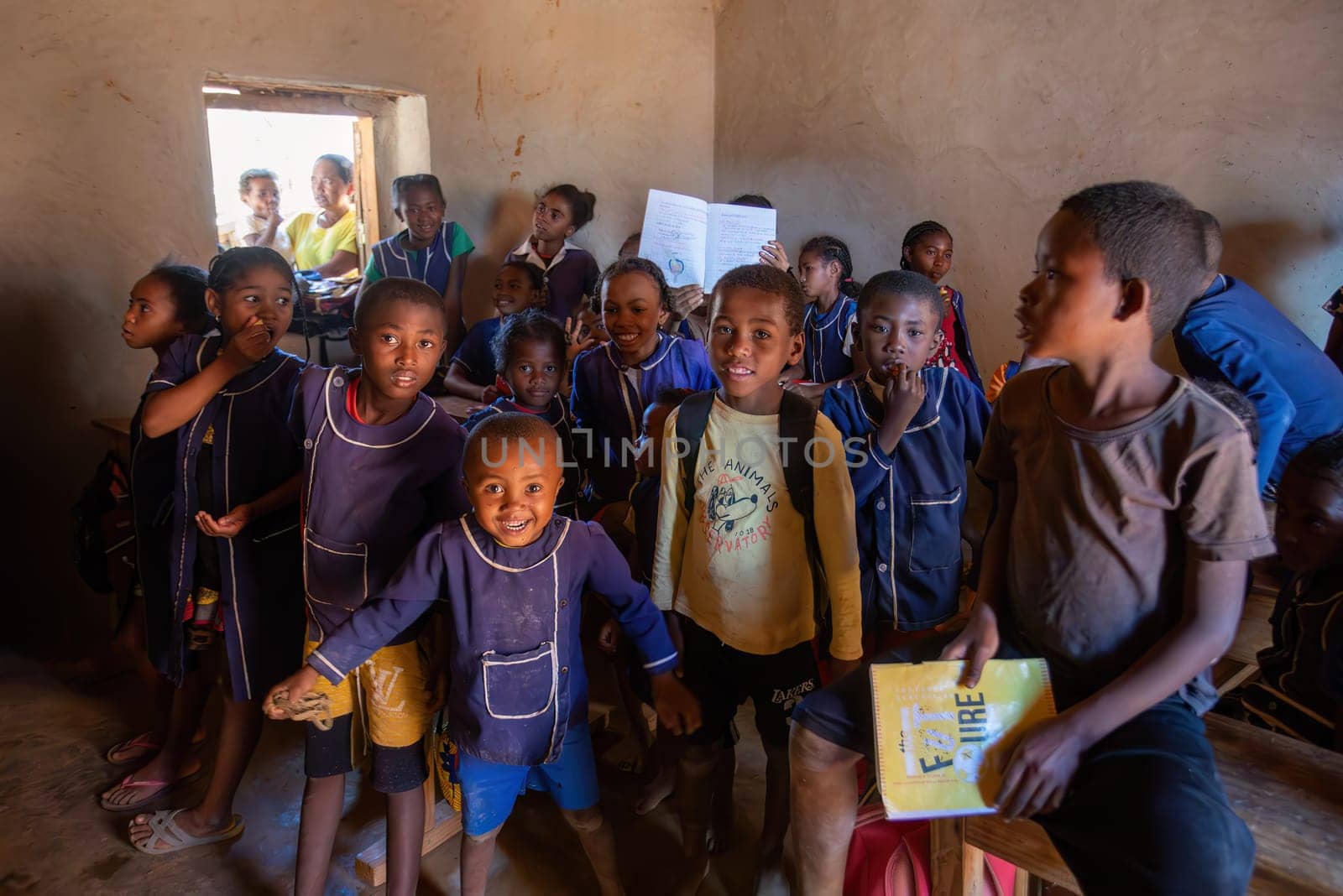Vohitsaoka, Ambalavao, Madagascar - November 17. 2022: Happy Malagasy school children students in classroom. School attendance is compulsory, but many children do not go to school.