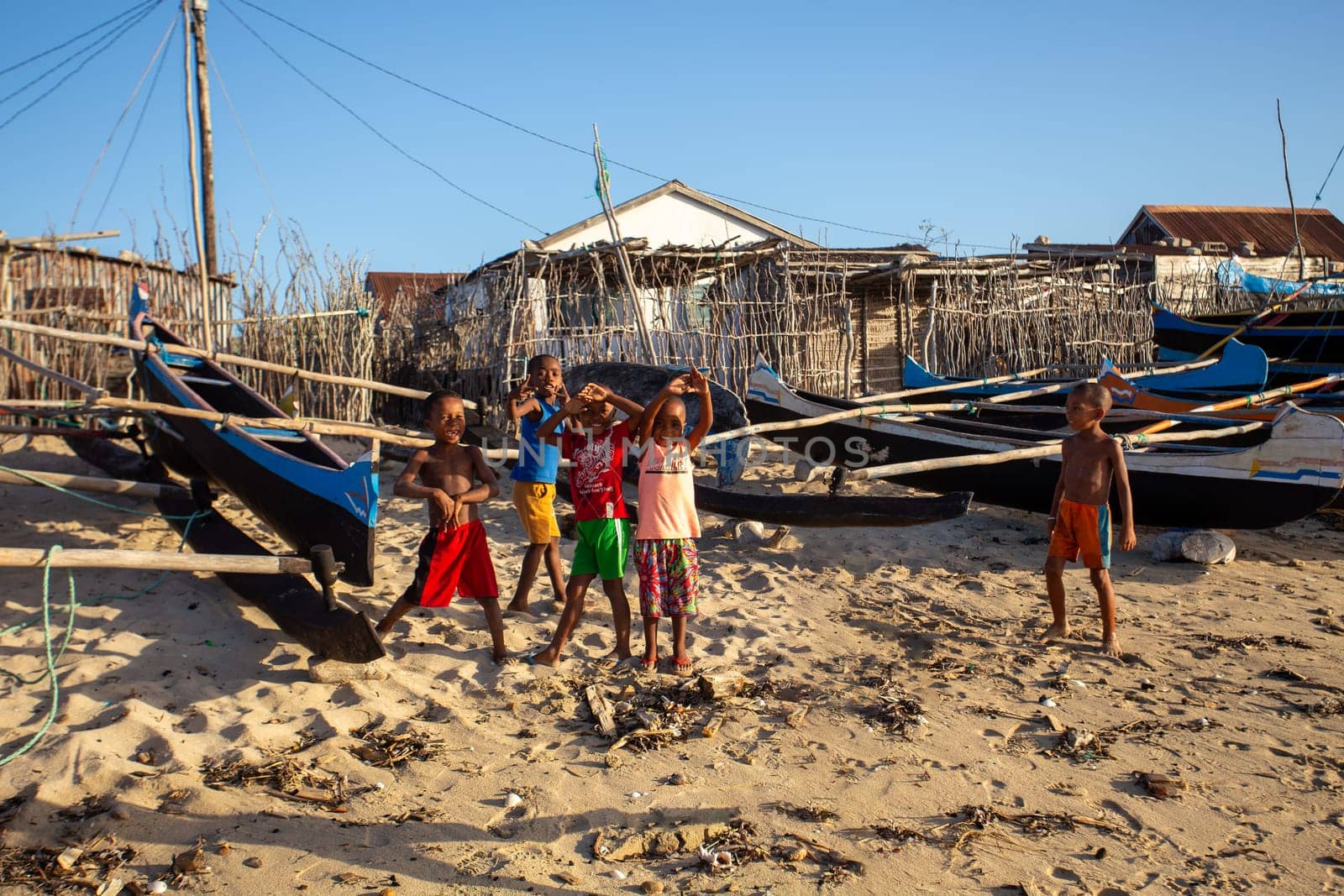 Anakao, Madagascar - November 21. 2022 - Group of Malagasy children frolicking on the beach near the fishing village of Anakao.