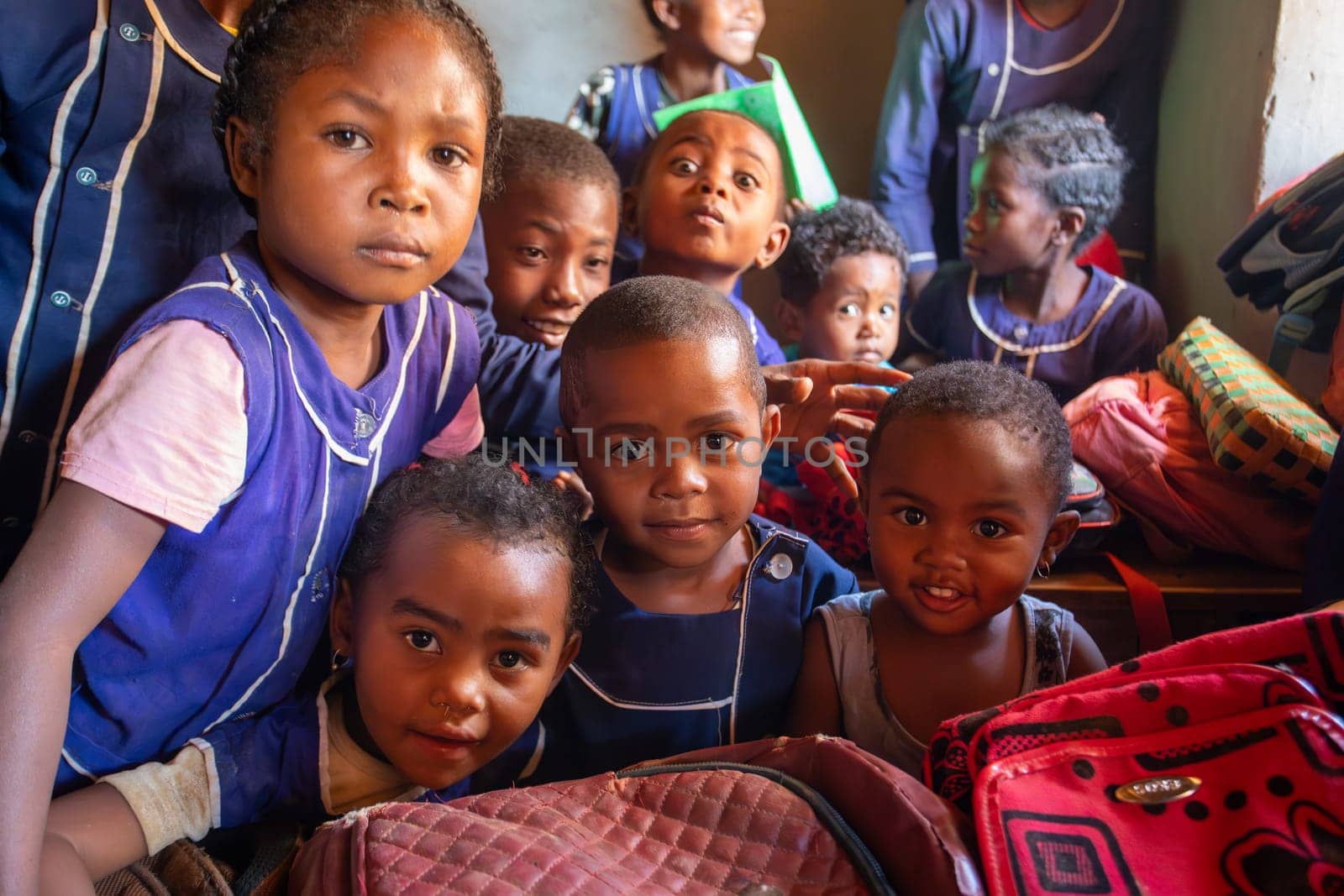 Vohitsaoka, Ambalavao, Madagascar - November 17. 2022: Happy Malagasy school children students in classroom. School attendance is compulsory, but many children do not go to school.