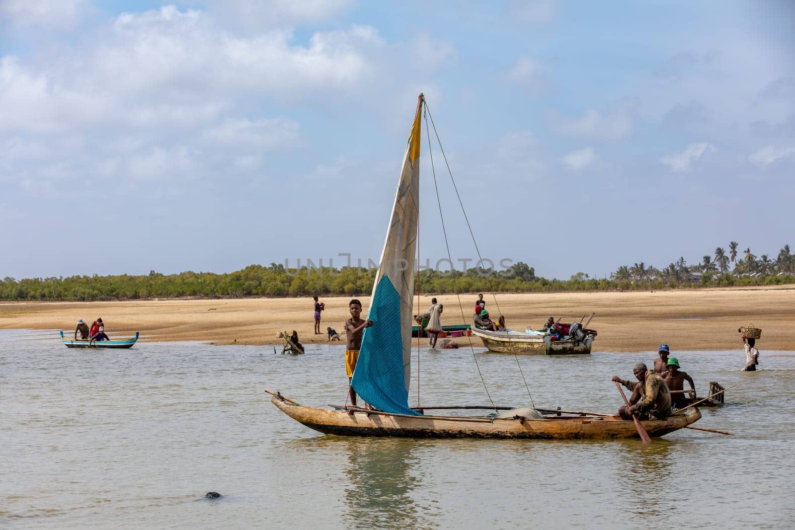 Morondava, Madagascar - November 3rd 2022: A fisherman sails back from the sea to the river on a sailboat in Morondava