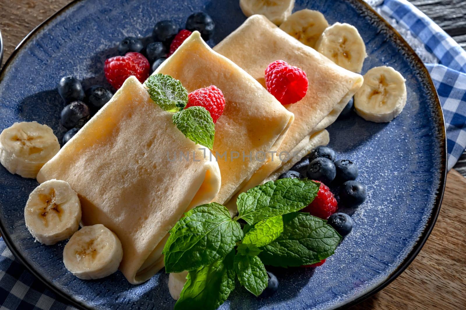 A plate of home-made Polish pancakes filled with sweet cottage cheese