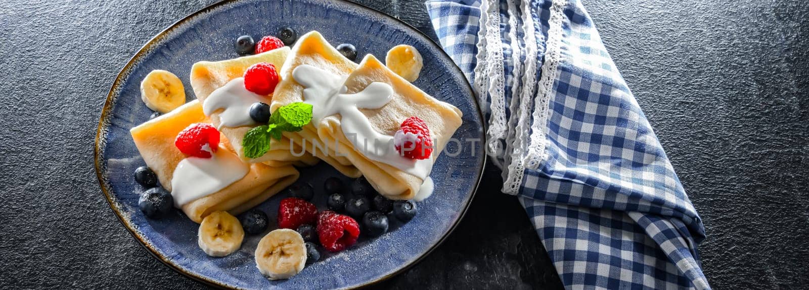 A plate of home-made Polish pancakes filled with sweet cottage cheese