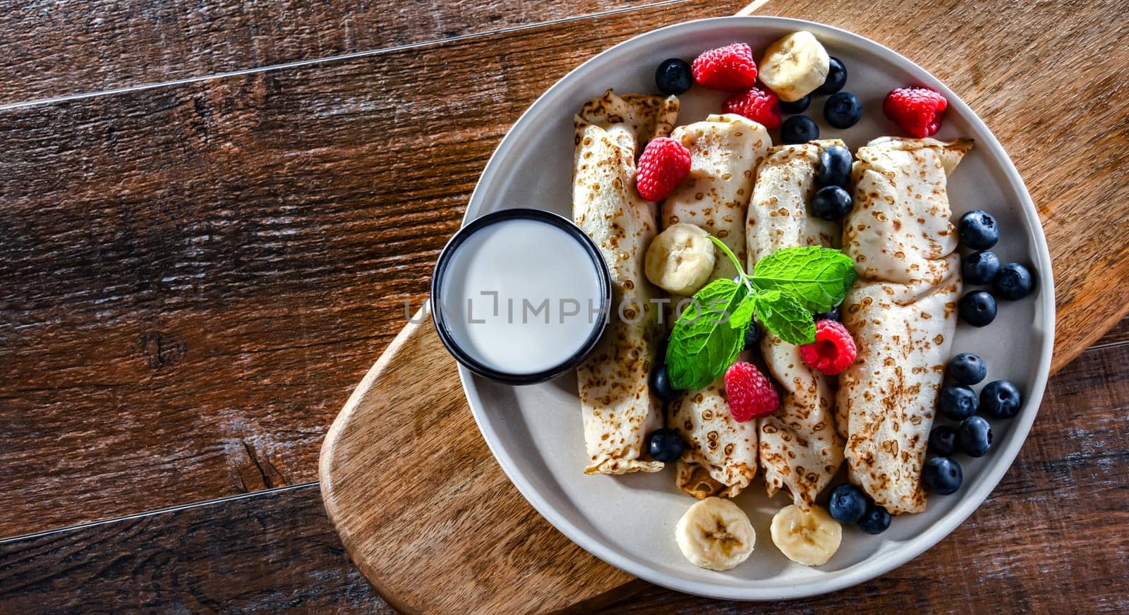 A plate of home-made Polish pancakes filled with sweet cottage cheese