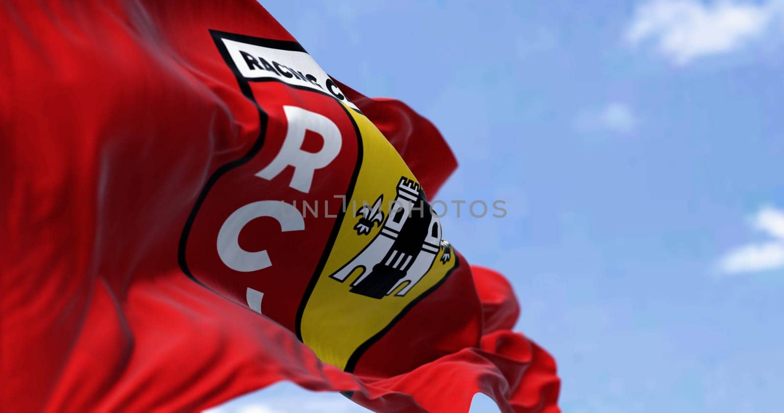 Lens, FR, Sept 3 2023: RC Lens flag waving in the wind on a clear day. French professional football club. ILlustrative editorial 3d illustration render. Selective focus. Fluttering fabric