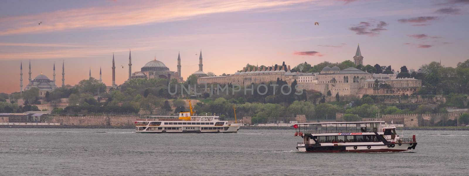 Istanbul, Turkey - May 5, 2023: View from Uskudar overlooking Bosphorus strait with Topkapi Palace and Hagia Sophia in the far end after sunrise