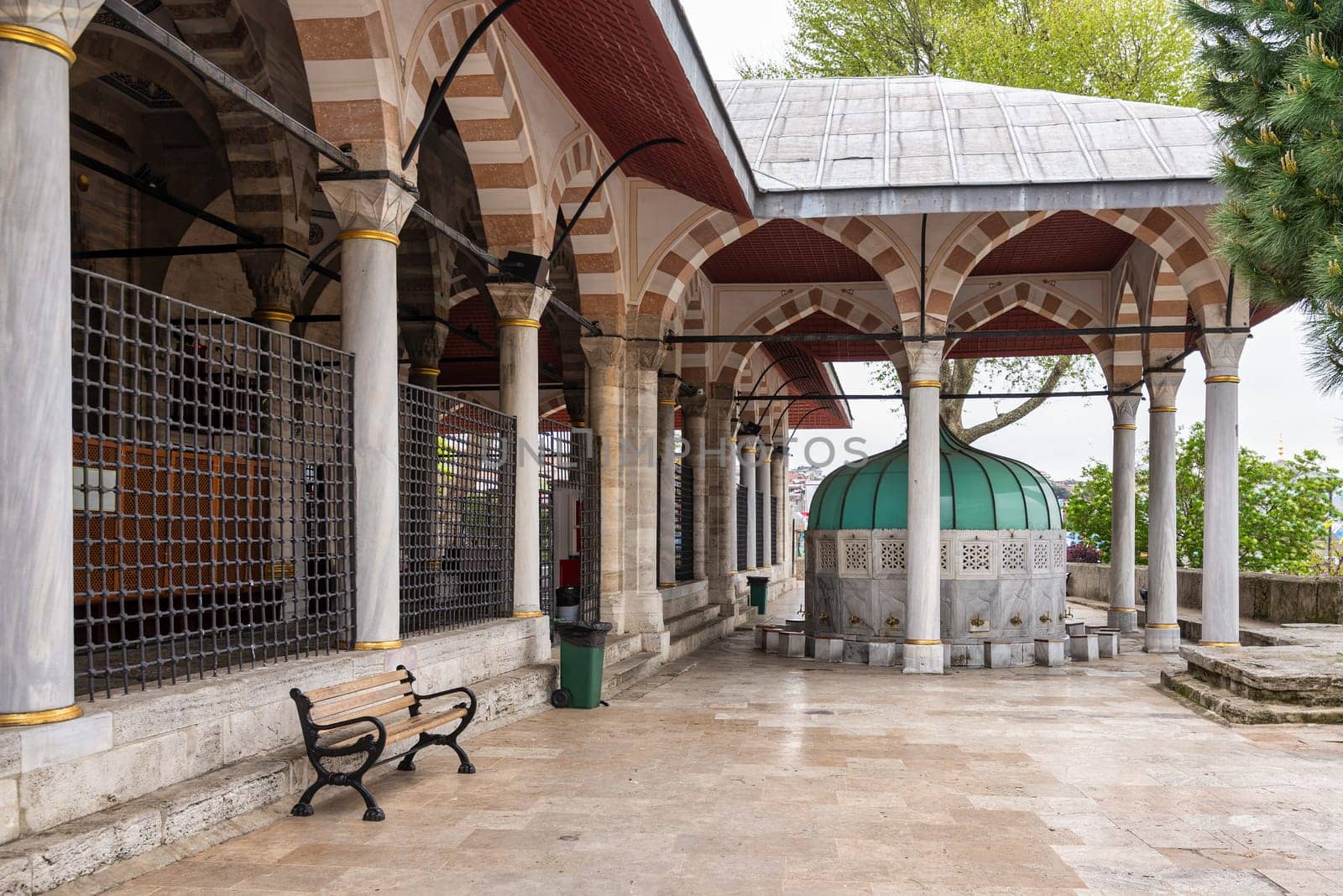 Ablution fountain in the courtyard of the Mihrimah Sultan Mosque in Uskudar, Istanbul, Turkey. The fountain is made of white marble and decorated with intricate carvings