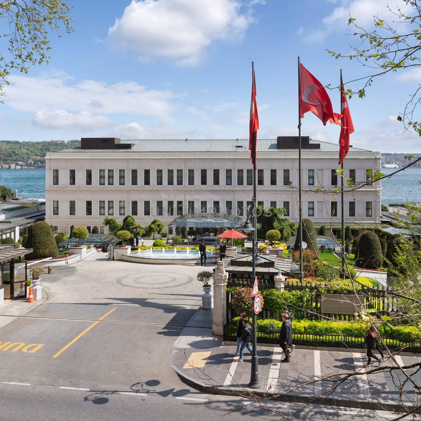 Istanbul, Turkey - May 7, 2023: View from Ciragan street of modern architectural design five stars Four Seasons hotel, suited by Bosphorus Strait, at Besiktas district, in a spring day